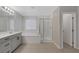 Bathroom with soaking tub, shower, and modern gray vanity at 356 Espressivo St, Henderson, NV 89011