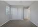 Spacious bedroom with gray carpet, closet, and access to hallway at 356 Espressivo St, Henderson, NV 89011