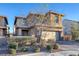 Two-story house with tan siding, a two-car garage, and landscaping at 356 Espressivo St, Henderson, NV 89011