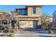 Two-story house with tan siding, a two-car garage, and landscaping at 356 Espressivo St, Henderson, NV 89011