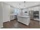 Modern kitchen with stainless steel appliances and an island at 356 Espressivo St, Henderson, NV 89011