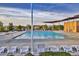 Community pool with lounge chairs and building at 356 Espressivo St, Henderson, NV 89011