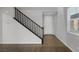 Modern black staircase with wood flooring and white walls at 356 Espressivo St, Henderson, NV 89011