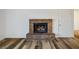 Brick fireplace in living room with wood-look floors at 3790 Shirebrook Dr # 98, Las Vegas, NV 89115