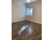 Simple bedroom with wood-look floors and a window at 9580 W Reno Ave # 114, Las Vegas, NV 89148