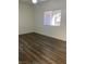 Bright bedroom featuring wood-look floors and a window with blinds at 9580 W Reno Ave # 114, Las Vegas, NV 89148