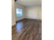 Bright living room featuring wood-look floors and a large window at 9580 W Reno Ave # 114, Las Vegas, NV 89148