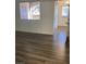 Living room with wood-look floors and access to patio at 9580 W Reno Ave # 114, Las Vegas, NV 89148