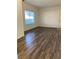 Living room featuring wood-look floors and a large window at 9580 W Reno Ave # 114, Las Vegas, NV 89148