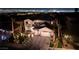 Night aerial view showcasing a luxurious home with a tile roof, palm trees, and the dazzling city lights in the background at 2781 Josephine Dr, Henderson, NV 89044