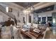 Open dining area with a wooden table set for six, stylish chandelier, and views into the living spaces at 2781 Josephine Dr, Henderson, NV 89044