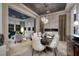 Elegant dining room with stylish lighting, marble floors, and an open layout connected to the living area at 2781 Josephine Dr, Henderson, NV 89044