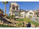 Beautiful two-story home showcasing lush landscaping, mature palm trees, and a charming water feature in the front yard at 2781 Josephine Dr, Henderson, NV 89044