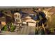 Aerial view of a luxurious two-story home with a tile roof, manicured landscaping, and a circular driveway leading to a 3-car garage at 2781 Josephine Dr, Henderson, NV 89044