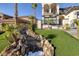 Captivating view of a home's water feature and tropical landscaping with palm trees at 2781 Josephine Dr, Henderson, NV 89044