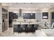 Modern kitchen featuring gray cabinets, stainless steel appliances, pendant lighting, and a spacious island with bar seating at 2781 Josephine Dr, Henderson, NV 89044