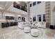 Open-concept living room with soaring ceilings, large windows, and a view of the modern kitchen and dining area at 2781 Josephine Dr, Henderson, NV 89044