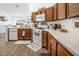 L-shaped kitchen with ample counter space and wood cabinets at 2525 Kirkmichael Ln, Henderson, NV 89014