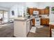 Bright kitchen with wood cabinets, white appliances, and a breakfast bar at 2525 Kirkmichael Ln, Henderson, NV 89014
