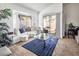 Living room with a bay window, seating area, and access to a patio at 2525 Kirkmichael Ln, Henderson, NV 89014