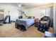 Large bedroom with a queen bed, exercise equipment, and ample floor space at 3544 Sandcliff Ln, Las Vegas, NV 89121