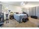 Bright bedroom with a queen-size bed, carpeted floors, and a ceiling fan at 3544 Sandcliff Ln, Las Vegas, NV 89121