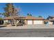 House exterior with a three car garage at 3544 Sandcliff Ln, Las Vegas, NV 89121