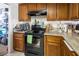 Kitchen with wood cabinets, granite counters and a gas stove at 3544 Sandcliff Ln, Las Vegas, NV 89121