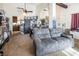 Open living room with gray couch and view into kitchen at 3544 Sandcliff Ln, Las Vegas, NV 89121