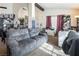 Spacious living room features a gray couch and access to the dining area at 3544 Sandcliff Ln, Las Vegas, NV 89121