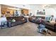 Open living room with kitchen views, comfortable seating and large windows at 3544 Sandcliff Ln, Las Vegas, NV 89121