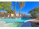 Backyard swimming pool and spa combination with rock features and lush landscaping, perfect for relaxing at 3544 Sandcliff Ln, Las Vegas, NV 89121