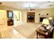 Open living room with fireplace, built-in media center, carpeted floor, neutral walls and view of the entryway at 7321 Gentle Valley St, Las Vegas, NV 89149