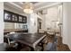 Bright dining room with tall ceilings, an oversized table, and built-in cabinets with glass doors at 913 Pro Players Dr, Las Vegas, NV 89134