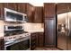 This kitchen showcases stainless steel appliances, dark cabinetry, and light countertops at 913 Pro Players Dr, Las Vegas, NV 89134