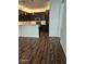 Open kitchen with stainless steel appliances and dark wood cabinets, complemented by wood flooring at 913 Pro Players Dr, Las Vegas, NV 89134