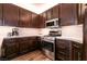 Featuring stainless steel appliances, wood cabinets, and light countertops in this well-lit kitchen at 913 Pro Players Dr, Las Vegas, NV 89134