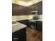Well-lit kitchen features stainless steel appliances, dark wood cabinets, and light countertops at 913 Pro Players Dr, Las Vegas, NV 89134