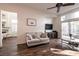Bright living room boasts hardwood floors, a cozy couch, and a large sliding glass door to a backyard at 913 Pro Players Dr, Las Vegas, NV 89134