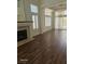 Open-concept living room with fireplace, hardwood floors, and natural light streaming through multiple windows at 913 Pro Players Dr, Las Vegas, NV 89134