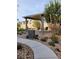 Enjoy the charming backyard seating area with a pergola, trash receptacle and a paved walkway at 10205 Starlit Canyon Ct, Las Vegas, NV 89141