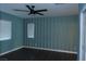 Bedroom with wood-look floors, ceiling fan, and blue striped accent wall at 117 Logan Pond Way, North Las Vegas, NV 89084