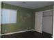 Bedroom with wood-look floors, window blinds, and painted accent at 117 Logan Pond Way, North Las Vegas, NV 89084