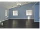 Large bedroom with chandelier, light blue walls, and laminate flooring at 117 Logan Pond Way, North Las Vegas, NV 89084