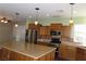 Modern kitchen with stainless steel appliances and an island at 117 Logan Pond Way, North Las Vegas, NV 89084