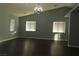 Bright living room with dark hardwood floors and large windows at 117 Logan Pond Way, North Las Vegas, NV 89084