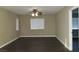 Spacious living room with ceiling fan and dark laminate flooring at 117 Logan Pond Way, North Las Vegas, NV 89084