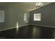 Bright living room with dark hardwood floors and large windows at 117 Logan Pond Way, North Las Vegas, NV 89084