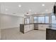 Open concept kitchen with island, stainless steel appliances, and light gray flooring at 3012 Plaza De Rosa, Las Vegas, NV 89102