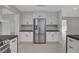 Modern kitchen with stainless steel refrigerator and white cabinets at 3012 Plaza De Rosa, Las Vegas, NV 89102